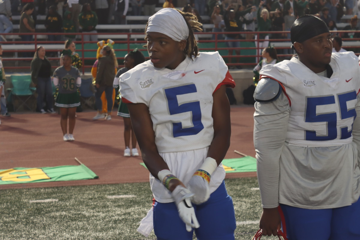 Dakoda Fields pulls on Oregon gloves ahead of a game against Long Beach Poly.
